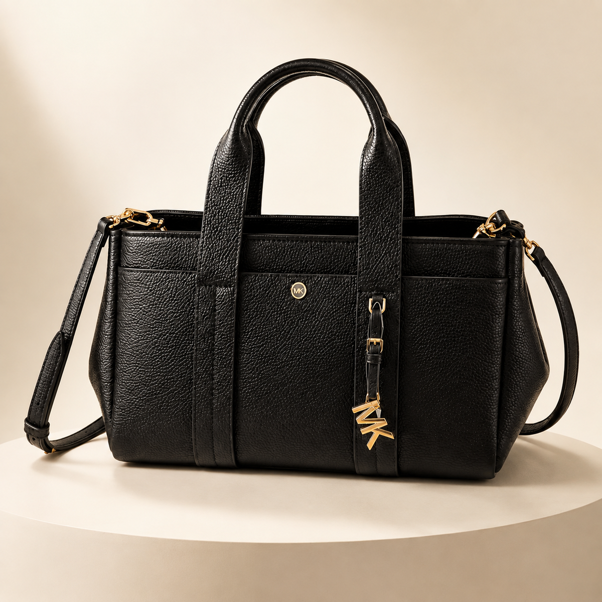 Michael Kors black pebbled leather tote bag with gold hardware and crossbody strap