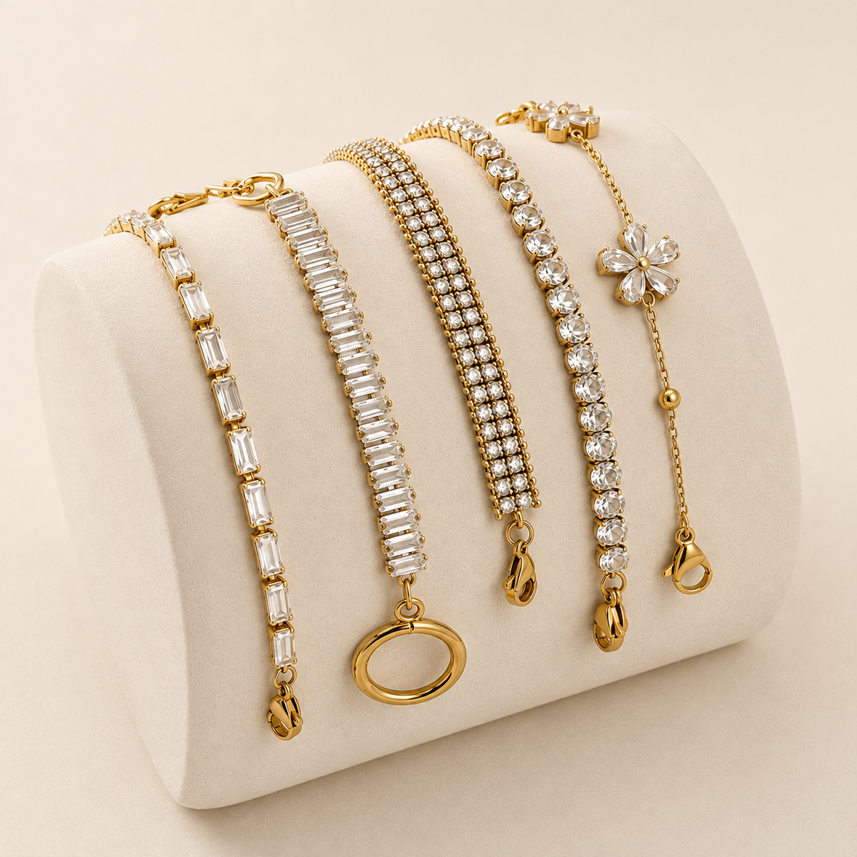 Gold plated bracelets stacked on wrist showing sparkling crystal and chain designs