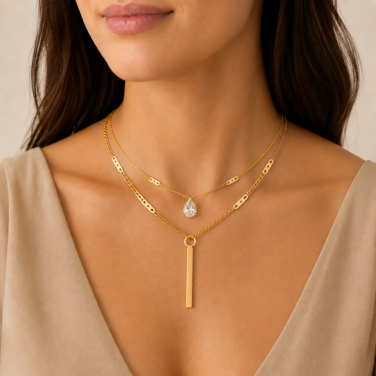 Gold layered necklaces with crystal and bar pendants in a luxury jewelry box
